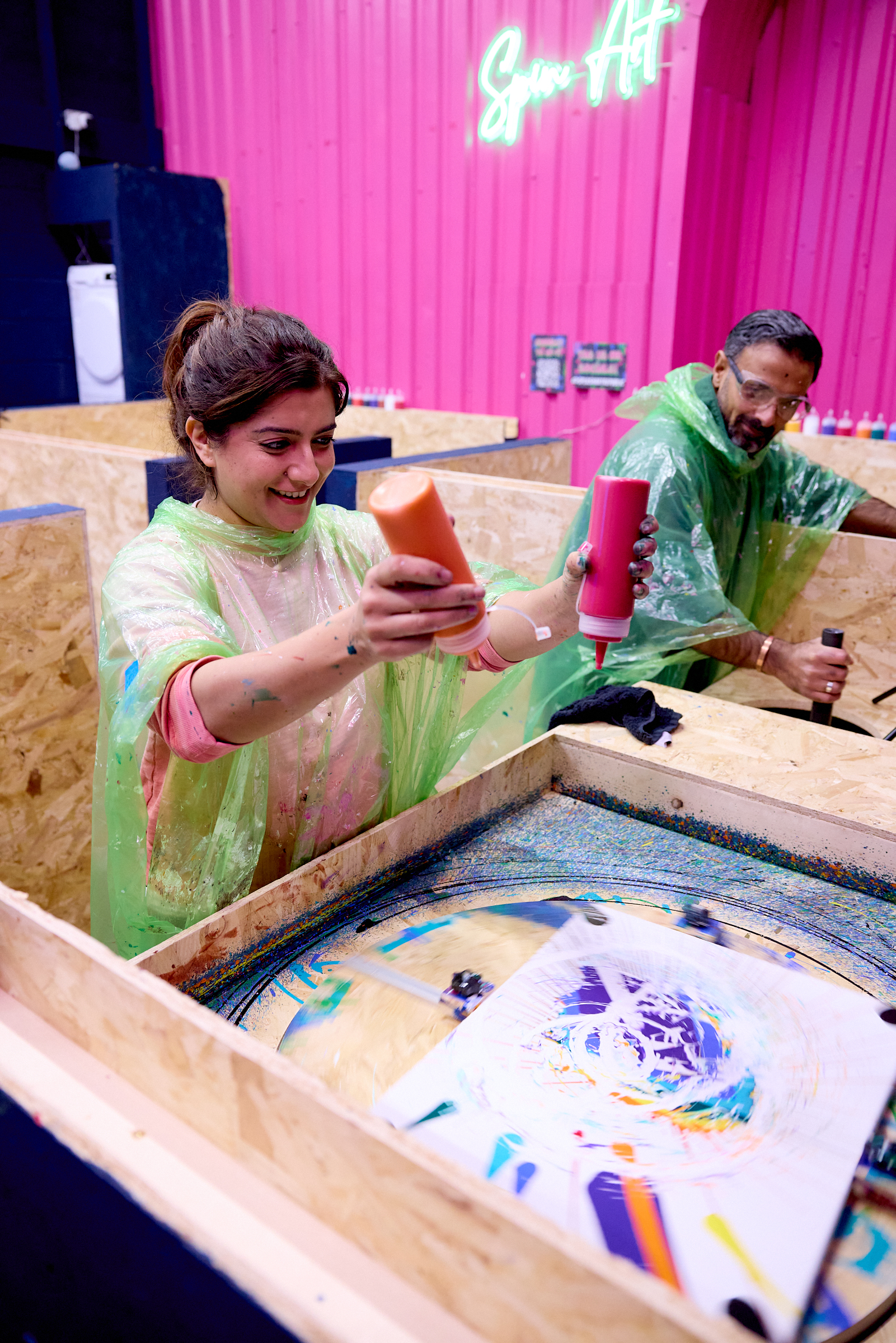 Visitors creating colourful spin art painting at Splash Art Republic interactive art studio