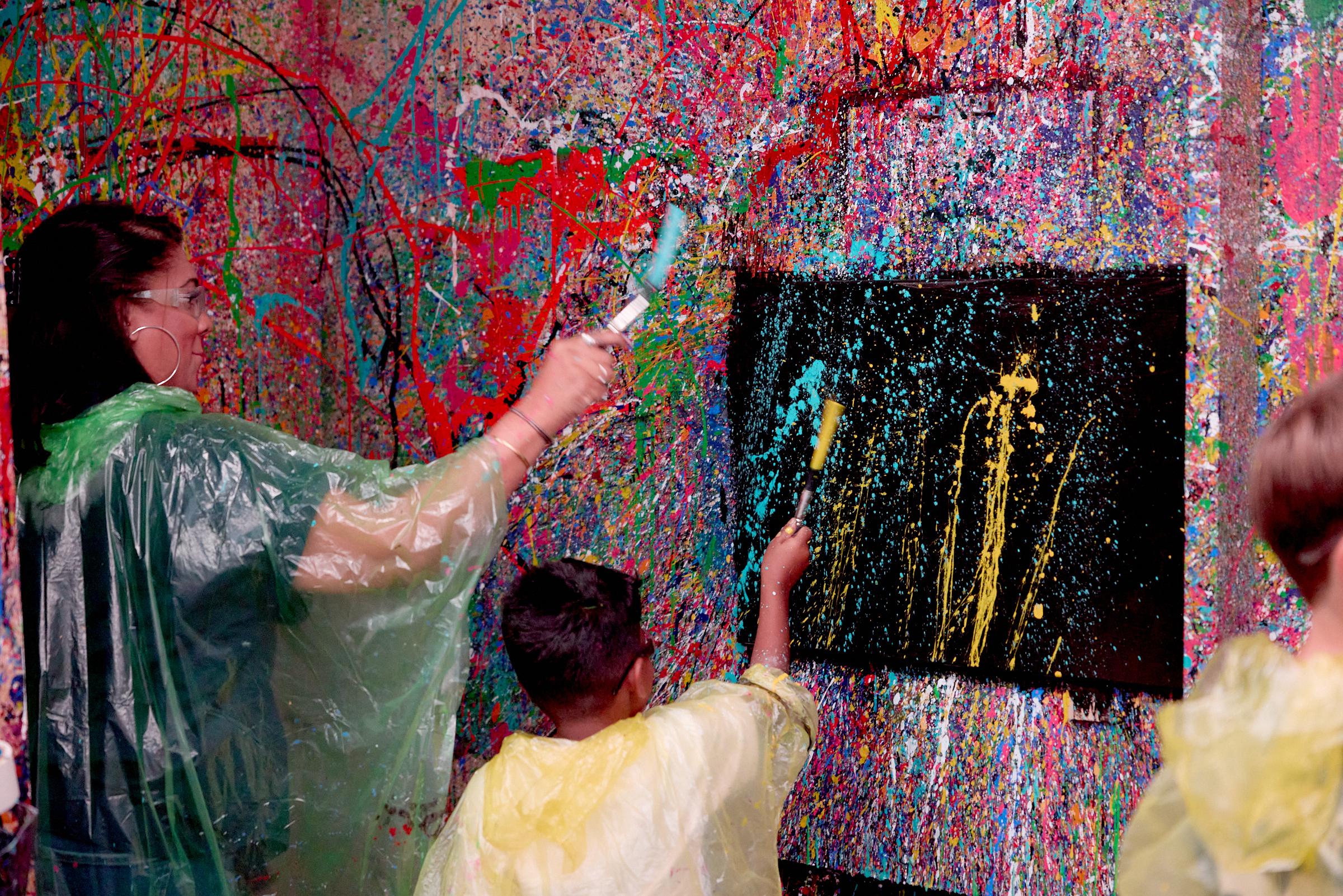 Family in the splatter art studio taking part in a splatter art experience